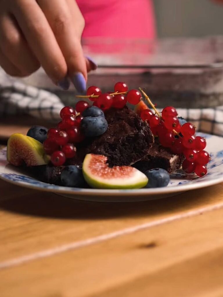 Delicious brownies with melted chocolate and fresh berries