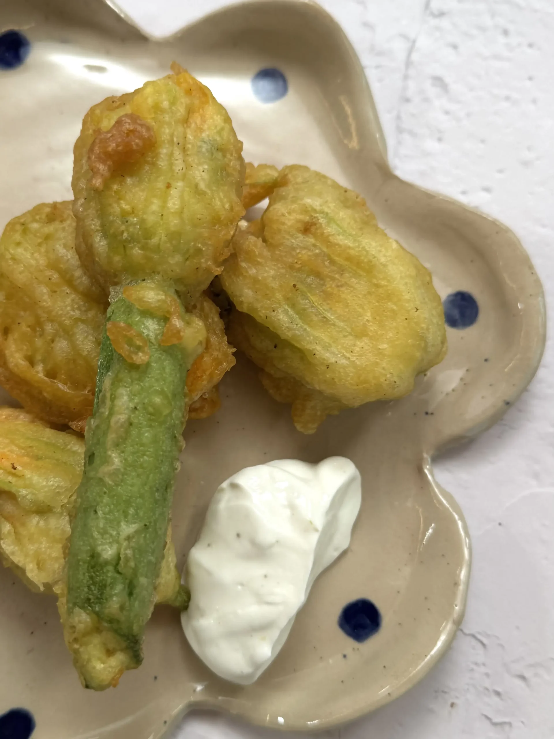 Crispy stuffed zucchini flowers with tomato & halloumi
