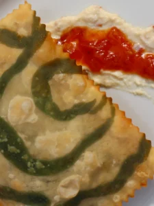 Mini hand pies with greens, caramelized onions & green olive paste